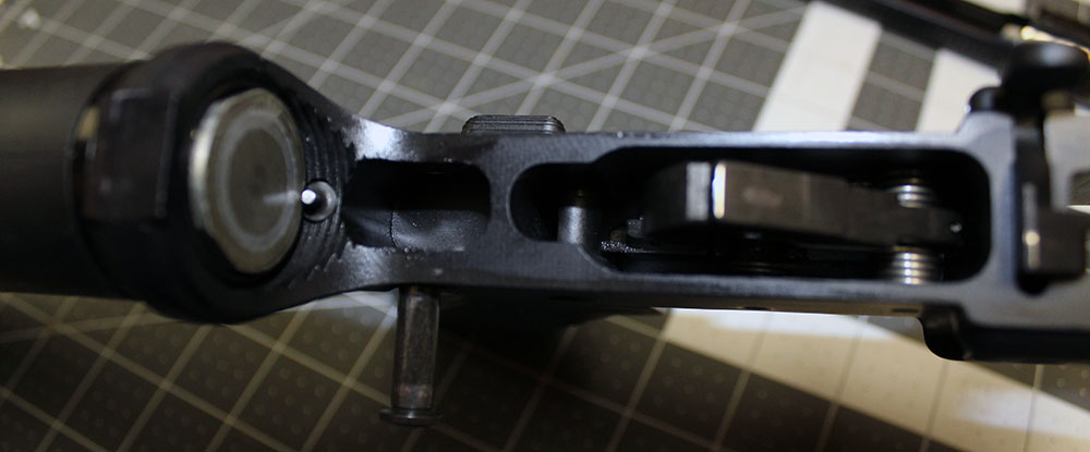 close-up into the lower, showing the recoil spring buffer and the hammer